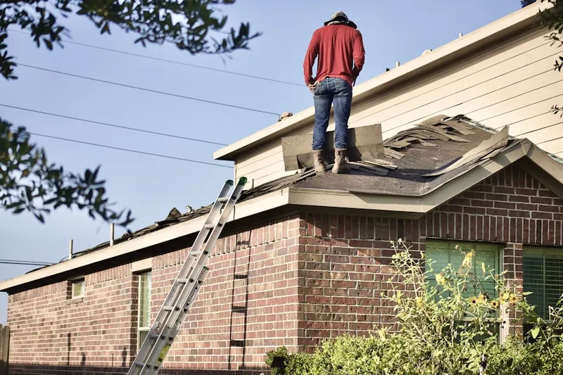 Professional roofer working on a residential roof in San Gabriel Heights